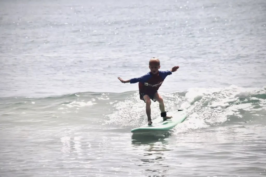 Kid enjoying Arugam Bay surfing lessons with our ISA guides at Baby Point beach by, One of the Best Arugam Bay Attractions Arugambay Agenda