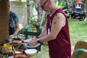 Man enjoying a hands-on Sri Lankan cooking Sigiriya, preparing traditional dishes and experiencing authentic local cuisine