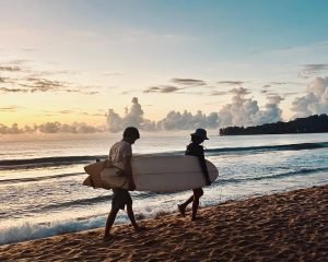 A couple heading to the Main Point Arugam Bay for the morning surf session, one of the best things to do in Arugam Bay