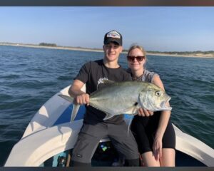 Australian couple holding freshly caught fish during a fishing tour in Arugambay with Arugambay Agenda near the Sri Lankan coast.
